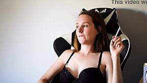 Busty Brunette Smokes Seductively in Black Bra