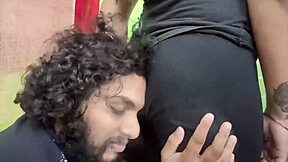 In a cozy bedroom, the cute young Indian couple shares sweet kisses and tender romantic moments together as loving husband and beautiful housewife.