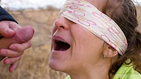 Blindfolded couple plays outdoor taste game with cumshots
